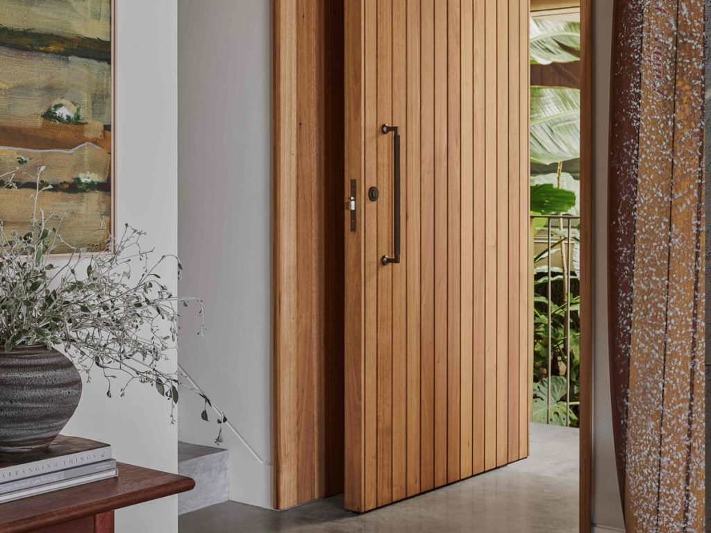 A tongue and groove clad pivot door in Silver Top Ash by Acacia in Palm Beach NSW