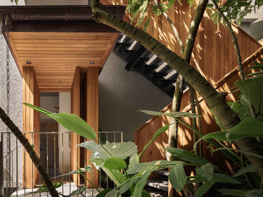 Timber pivot door and the external stair case at the entrance of a multi-storey Palm Beach home
