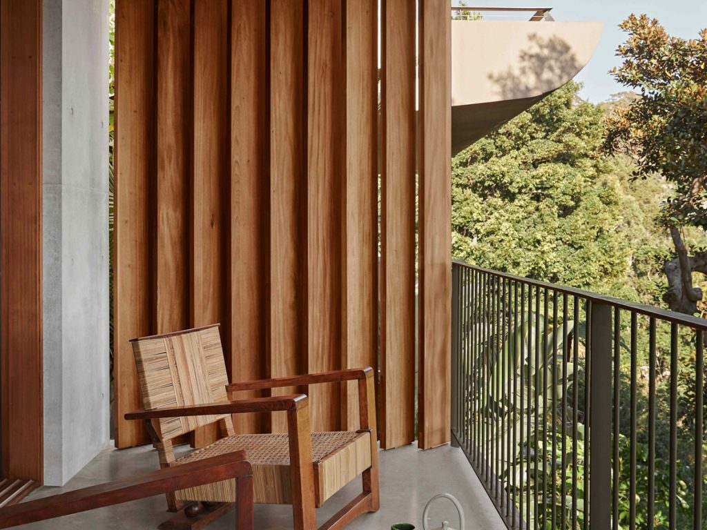Vertical timber louvres at the side of a balcony providing privacy from neighbouring properties in Palm Beach NSW