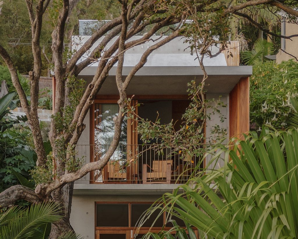 Rear exterior view of a multi-storey small footprint Palm Beach property. The timber stacker sliding doors in Blackbutt are a feature of this property.