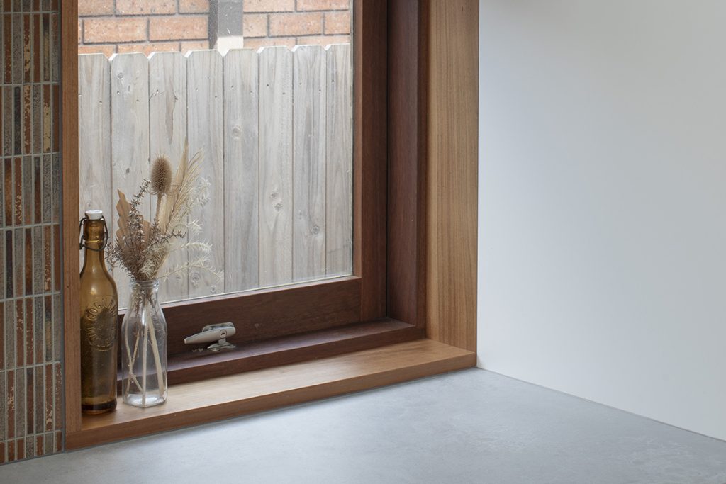 A beautiful timber awning window in the kitchen of Re-Grow/Re-Wild House by Bastian Architecture